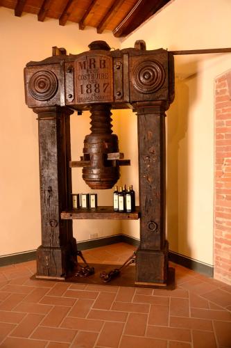 a room with a table with bottles of wine at Monastero Sant'Anna in Camprena in Pienza