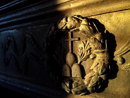 a metal object with a cross and fruit on it at Monastero Sant'Anna in Camprena in Pienza