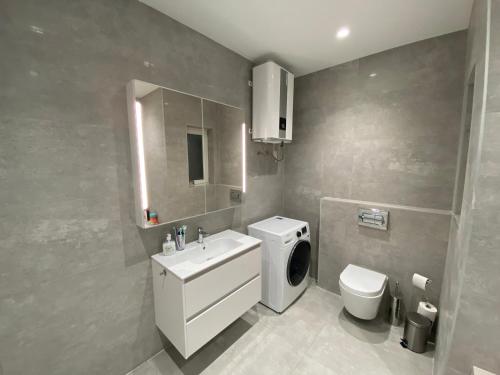 een badkamer met een witte wastafel en een toilet bij A52 - Apartment with Sea and Country Views in Mellieħa