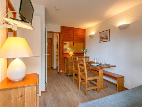 une cuisine et une salle à manger avec une table et des chaises dans l'établissement Studio cabine au pied des pistes, idéal pour 4 personnes, proche village enfants, parking inclus - FR-1-694-66, à Val dʼIsère