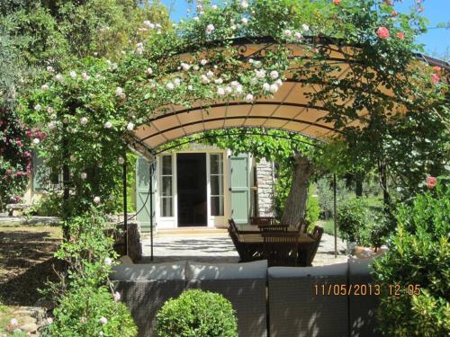 a pergola with a bench in a garden at Charming, chic, secluded villa within walking distance from Lorgues in Lorgues