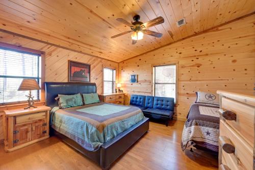 a bedroom with a bed and a ceiling fan at Broken Bow Cabin with Hot Tub and Covered Deck! in Stephens Gap
