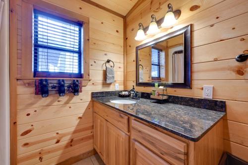a bathroom with a sink and a mirror at Broken Bow Cabin with Hot Tub and Covered Deck! in Stephens Gap