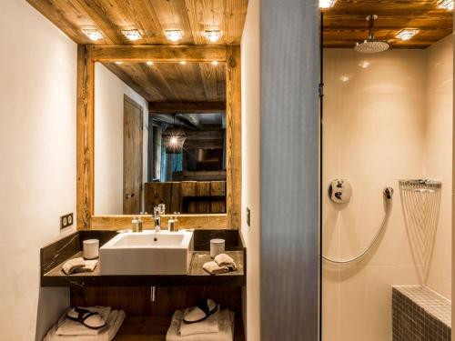 a bathroom with a sink and a mirror and a shower at Chalet Val-d'Isère, 7 pièces, 10 personnes - FR-1-694-95 in Val-d'Isère