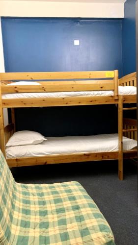 two bunk beds in a room with a blue wall at Hotel de la Basilique in Paray-le-Monial