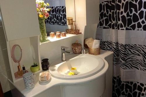 a bathroom with a white sink and a mirror at Giannis Traditional House in Vamos