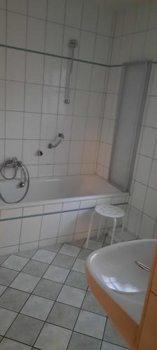 a bathroom with a tub and a toilet and a sink at Pension Sorrento in Ruhland