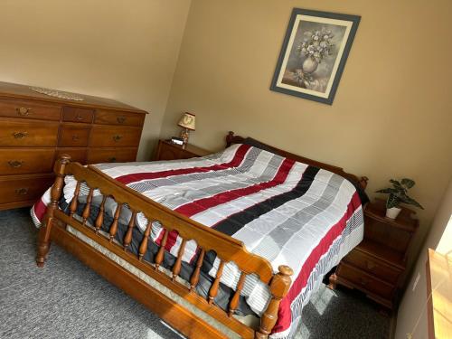 a bedroom with a bed with a striped comforter at Pershing Heights 103 in New Kensington