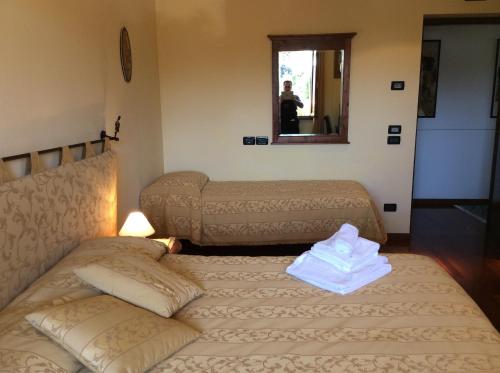 a hotel room with two beds and a mirror at Locanda Da Vittorio in Manerba del Garda