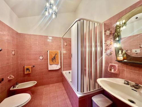 y baño de color rosa con lavabo y ducha. en [Monzuno] Elegant Mansarda, en Monzuno