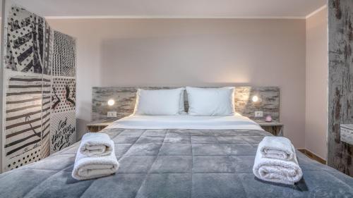 um quarto com uma cama grande e toalhas em Pink Sand-Studio em Agios Padeleimon
