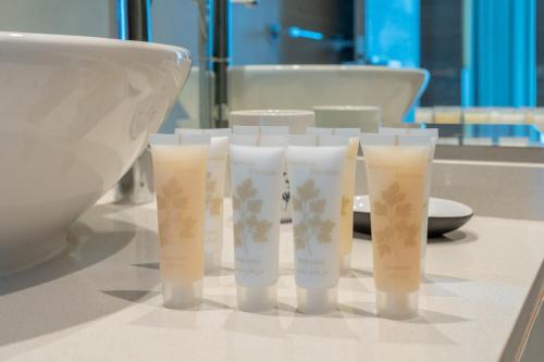 a group of four cups sitting on a table at LUXFolio Retreats - In The Heart Of Marina in Dubai Marina