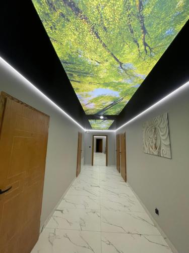 a hallway with a ceiling with a painting on it at MAŁY KSIĄŻĘ in Podzamcze