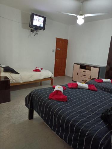 a bedroom with two beds with red and white towels at Ashpa newen in Chilecito