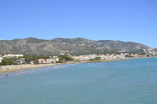 a view of a beach with people in the water at Apartments Kione Playa Romana Park in Alcossebre