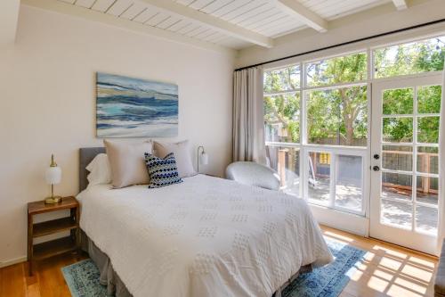 a bedroom with a bed and a large window at Vacation Rental Home about 1 Mi to Carmel Beach! in Carmel