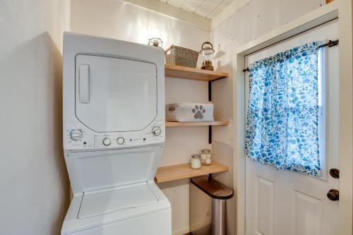 a white washer and dryer in a tiny house at Vacation Rental Home about 1 Mi to Carmel Beach! in Carmel