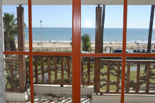 a view of the beach from a window at Apartments Kione Playa Romana Park in Alcossebre
