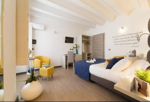 a bedroom with a bed and a desk in a room at Palazzo Sisto Exclusive Rooms in Catania