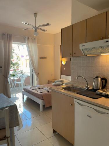 a kitchen with a sink and a counter top at Andy’s apartments in Georgioupolis