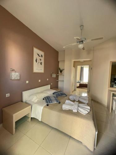 a bedroom with a bed with towels on it at Andy’s apartments in Georgioupolis