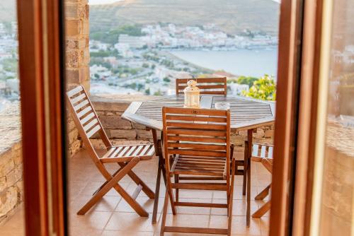 a table and chairs on a balcony with a view at Villa Cavo d' Oro in Korissia