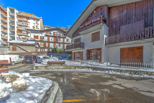 a parking lot with snow on the ground and buildings at CASA JULIE - Accogliente rifugio nella quiete - COUR 0157 in Courmayeur