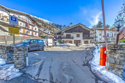 a car parked on a snow covered street with buildings at CASA JULIE - Accogliente rifugio nella quiete - COUR 0157 in Courmayeur