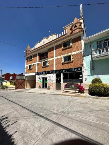 an empty street in front of a brick building at Hotel Villa Del Rey in Zaragoza