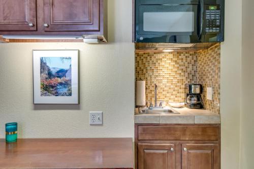 a kitchen with a sink and a microwave at Half-Mi to Light Rail Greenwood Village Studio in Englewood