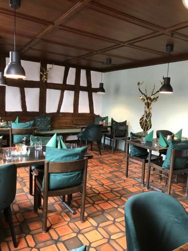 a restaurant with tables and chairs in a room at Gasthaus zum Goldenen Kreuz in Rafz