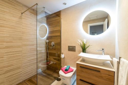 a bathroom with a sink and a shower at Villa Caleta Del Sol by Villa Plus in Caleta De Fuste