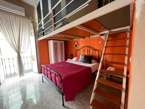 Cama o camas de una habitación en La Maestranza Apartment Rooms