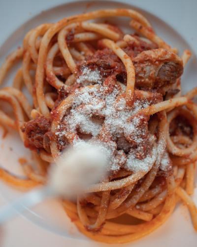 a plate of spaghetti with powdered sugar on top at Agri-Hotel Da Marianna Resort & Spa in Santa Domenica Vittoria