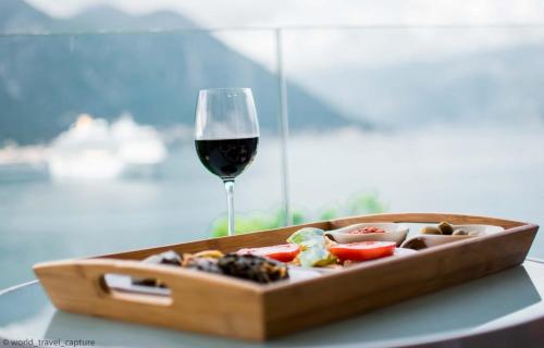 a plate of food and a glass of wine at Teo's place in Kotor