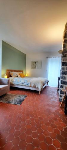 a bedroom with a large bed and a fireplace at Mas Bella Vida in Puget-Théniers