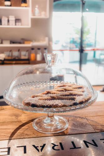 a cake on a glass plate on a table at Albergo Centrale in Lamezia Terme