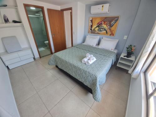 a bedroom with a bed with a teddy bear on it at Luxor Paulo Miranda Home Service in João Pessoa