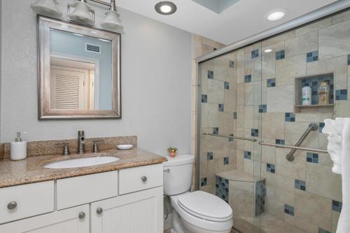 a bathroom with a toilet and a sink and a shower at Tropical Oasis 809 in Naples