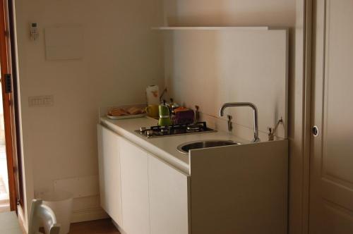 a kitchen with a sink and a counter top at Profumo Di Gelsomino in Scicli