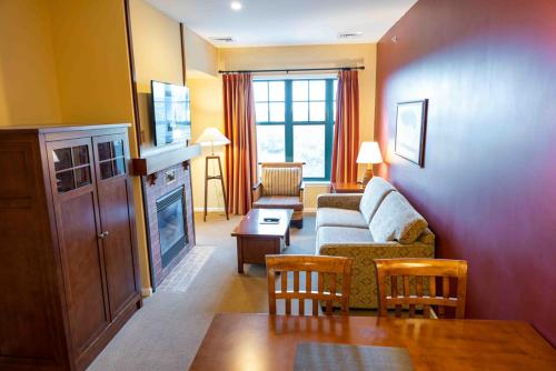 a living room with a couch and a table at The Appalachian at Mountain Creek in Vernon