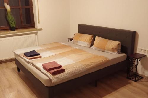 a bed in a room with two towels on it at Geräumige Ferienwohnung 90 sqm im Erholungsort in Bestwig