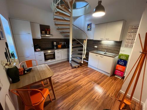 a kitchen with a spiral staircase and a table and chairs at Ferienhaus Renate in Meiningen