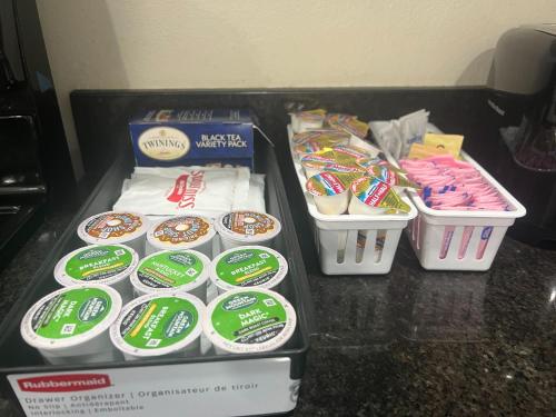 a table topped with boxes of donuts and other snacks at Hummingbird Haven 7 w King bed free parking Patio in Pharr
