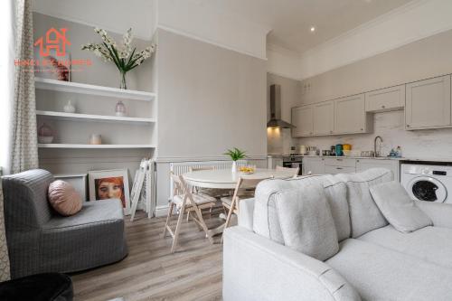 a living room with a couch and a table at Large Deluxe City Centre Apartment - Goergian Townhouse- Rodney St in Liverpool