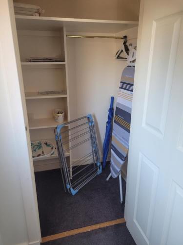 a room with a closet with a cart in it at Arisaig Flat in Inverness