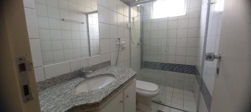 a white bathroom with a sink and a toilet at APT. 2/4 - Prive das Thermas I - 7 piscinas termal - Apclube Tur in Caldas Novas