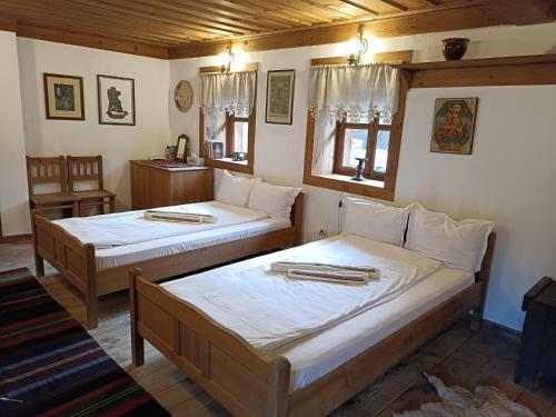 a bedroom with two beds in a room at Къща за гости Кануш войвода in Kovachevitsa