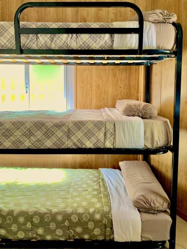 three bunk beds in a room with a window at Hostel Best Stay in Madrid