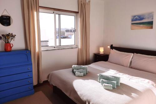 a bedroom with a bed with two stuffed animals on it at Penthouse Apartment, City Center in Caldas da Rainha